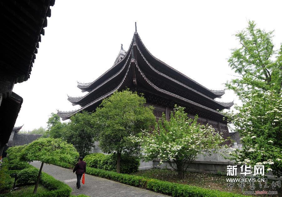 4月16日，一位市民从即将展出《四库全书》首套复制件的扬州天宁寺万佛楼附近走过。